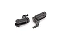 Two black plastic RC helicopter main blade grips with integrated ball links and visible bearings on a white background.