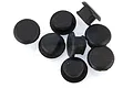 A group of eight small black rubber plugs for RC gear plates arranged on a white background.