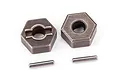 Two Traxxas steel 12mm wheel hex adapters with two matching drive pins on a white background.