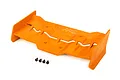 An orange Traxxas RC rear wing with four small black mounting screws placed in front of it on a white background.