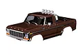 A brown Traxxas 1/18 1979 Ford F-150 RC truck body shell with a chrome roll bar and roof-mounted lights, shown against a white background.