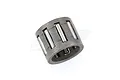 A close-up studio shot of a small cylindrical gudgeon pin roller bearing for an RC engine.