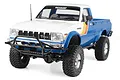 RC4WD Trail Finder 2 1982 Toyota Pickup RC rock crawler in blue and white with retro decals, shown from a front three-quarter angle on a white background.