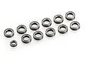 A collection of eleven metal ball bearings of varying sizes arranged on a white background.
