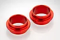 Two red anodized aluminium shock spring connectors for RC vehicles, shown on a white background.