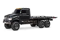 A studio shot of the black Traxxas TRX-6 Ultimate 6X6 Hauler RC truck from a side-angle view against a white background.
