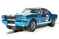 A blue Scalextric 1/32 scale Shelby Mustang GT350 slot car with white racing stripes and the number 133 on the side, positioned on a slot car track.