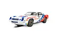 A 1/32 scale Scalextric Chevrolet Camaro Z28 slot car in white, red, and blue livery with American Car Service branding and number 77.