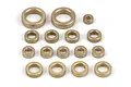A collection of various sized brass bushings arranged on a white background.