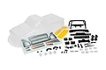 HPI Racing clear Toyota Hilux SR5 RC body shell with included decal sheet, black plastic accessories, and hardware components on a white background.