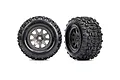 Two Traxxas Sledgehammer RC monster truck tyres mounted on charcoal grey multi-spoke wheels against a white background.