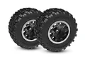 Two Traxxas Sledgehammer monster truck tyres mounted on black and satin wheels, shown from a front-quarter angle against a white background.