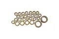 A collection of various sized bronze-coloured metal bushings arranged on a white background.
