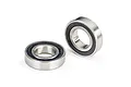 Two Traxxas rubber-shielded ball bearings shown on a white background, one lying flat and one standing upright.