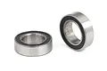 Two small metal ball bearings with black rubber seals, shown from different angles on a white background.