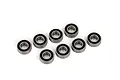 Eight metal ball bearings with black rubber seals arranged on a white background.