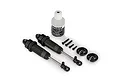 Two grey Traxxas GTR shock absorbers, a bottle of shock oil, and small mounting hardware on a white background.