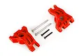 Two red Traxxas heavy duty rear sub axle carriers with included metal hinge pins and screws on a white background.