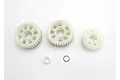 Traxxas output gear set including three white plastic gears, a small white spacer, and a metal washer on a white background.