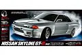 Product box art for Tamiya TT-02D Nissan Skyline GT-R R32 RC drift car, featuring a silver model car drifting on a dark background.