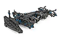 Team Associated TC8 touring car chassis kit showing carbon fiber, black plastic, and blue anodized aluminum components on a white background.