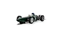 A 1/32 scale Scalextric 1962 BRM P57 slot car in British Racing Green, featuring a driver figure and racing number 17, positioned on a slot track section.