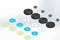 A digital render of MIP 16mm 8-hole bypass pistons, including black piston discs, small metal spacers, and various coloured thin washers.