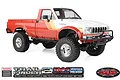 RC4WD Trail Finder 2 1982 Toyota Pickup RC rock crawler in red and white with chrome wheels and off-road tires on a white background.