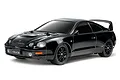 A studio shot of a black Tamiya Toyota Celica GT-Four RC car on a white background.