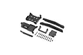 A collection of black plastic RC chassis parts and small metal screws laid out on a white background.