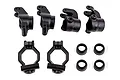 A set of black plastic RC car suspension parts including caster blocks, steering blocks, rear hubs, and spacers on a white background.