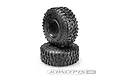 Two JConcepts Tusk crawler tyres stacked on a white background, showing aggressive tread patterns and sidewall branding.