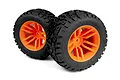 Two Maverick 2.8 inch MixBlok monster truck tyres pre-glued onto bright orange multi-spoke plastic rims, shown against a white background.