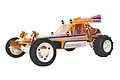 A studio shot of the Team Associated RC10 Classic 2WD RC buggy, featuring an orange body, white wheels, and gold-anodized shock absorbers.
