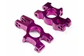 Two purple anodized aluminium rear hub carriers for an RC truggy, shown from an angled perspective on a white background.