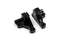 Two black anodized aluminium RC front lower arm mounts by Yeah Racing, shown from an elevated angle on a white background.