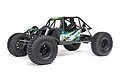 Axial AXP8 Gilamon 2.2 RC rock crawler in green, featuring a tube chassis, large off-road tires, and detailed driver figures.