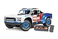 ARRMA Mojave Grom 1/16 scale RC short course truck in white, red, and blue livery, shown with its included LiPo battery and USB charger.