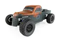 Team Associated Trophy Rat 1/10 scale RC trophy truck with a weathered, rusted-look olive green body, black wheels, and off-road tires.