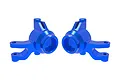A pair of bright blue anodized aluminium steering hubs for Traxxas RC vehicles, shown against a plain white background.