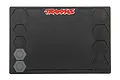 A black rectangular Traxxas rubber pit mat with a red and white Traxxas logo at the top and molded hexagonal compartments for organizing parts.