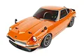 A high-angle studio shot of an orange Team Associated Apex2 Datsun 240Z RC car on a white background.