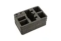 A black foam insert for a Spektrum transmitter case with pre-cut compartments for a radio and accessories.
