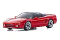 A studio shot of a red Kyosho Mini-Z Honda NSX RC car on a white background, showing the sleek sports car body and silver wheels.