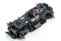 Kyosho Mini-Z MA-030EVO chassis kit showing the black plastic frame, red brushless motor, and wiring against a white background.