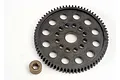 A dark grey plastic spur gear with a central hole and multiple circular cutouts, accompanied by a small bronze-coloured metal hex spacer.
