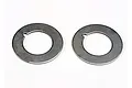 Two circular metal Traxxas slipper clutch pressure plates with a small notch on the inner diameter, shown against a white background.