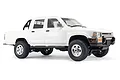 A white 1/16 scale WPL D64 Hilux RC rock crawler pickup truck viewed from the side against a white background.