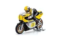 Kyosho Yamaha YZR500 RC motorcycle model with rider figure in yellow and black racing gear, mounted on a silver display stand against a white background.
