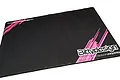 A rectangular black Bittydesign pit mat with pink graphic accents and white branding text on a white background.